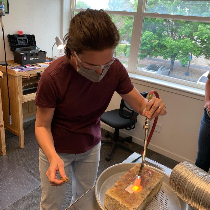 Student practicing heating metal