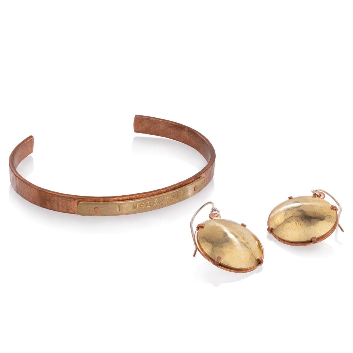 Mixed metal bracelet with rivets and earrings that have tab connections, both examples of cold connections in jewelry