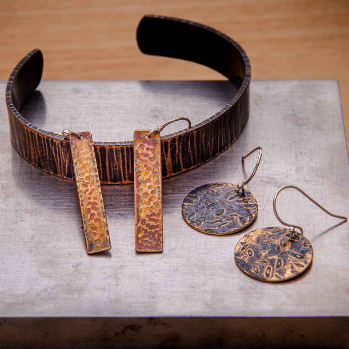 Patinas on copper and brass jewelry workshop in Lafayette, CO.