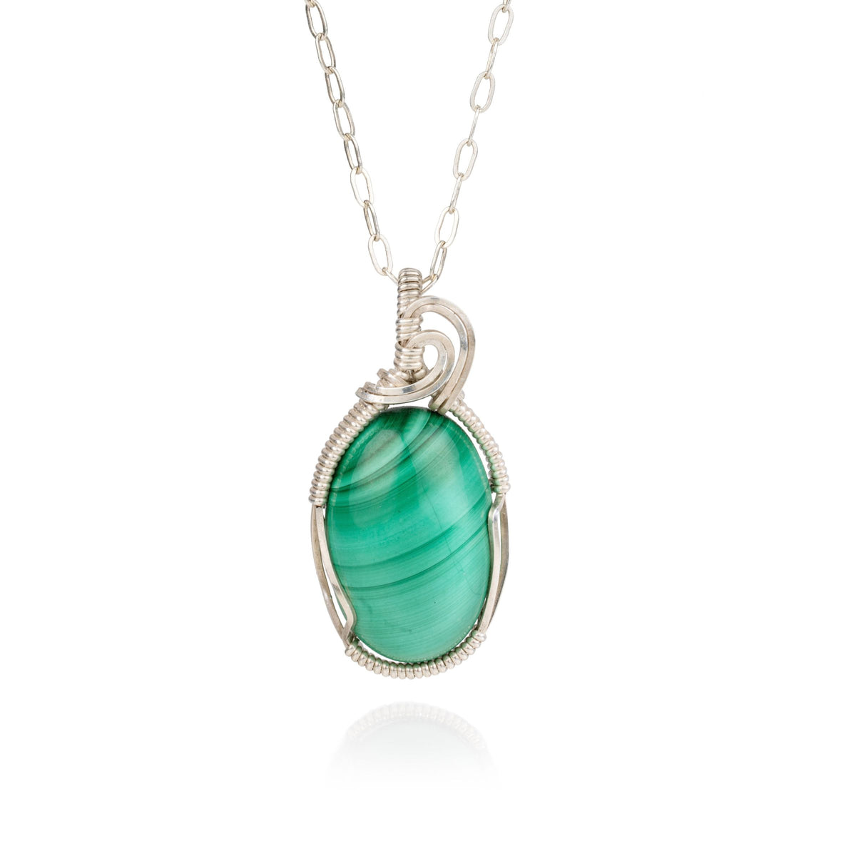 Green malachite stone that has been wire wrapped in sterling silver to create a pendant