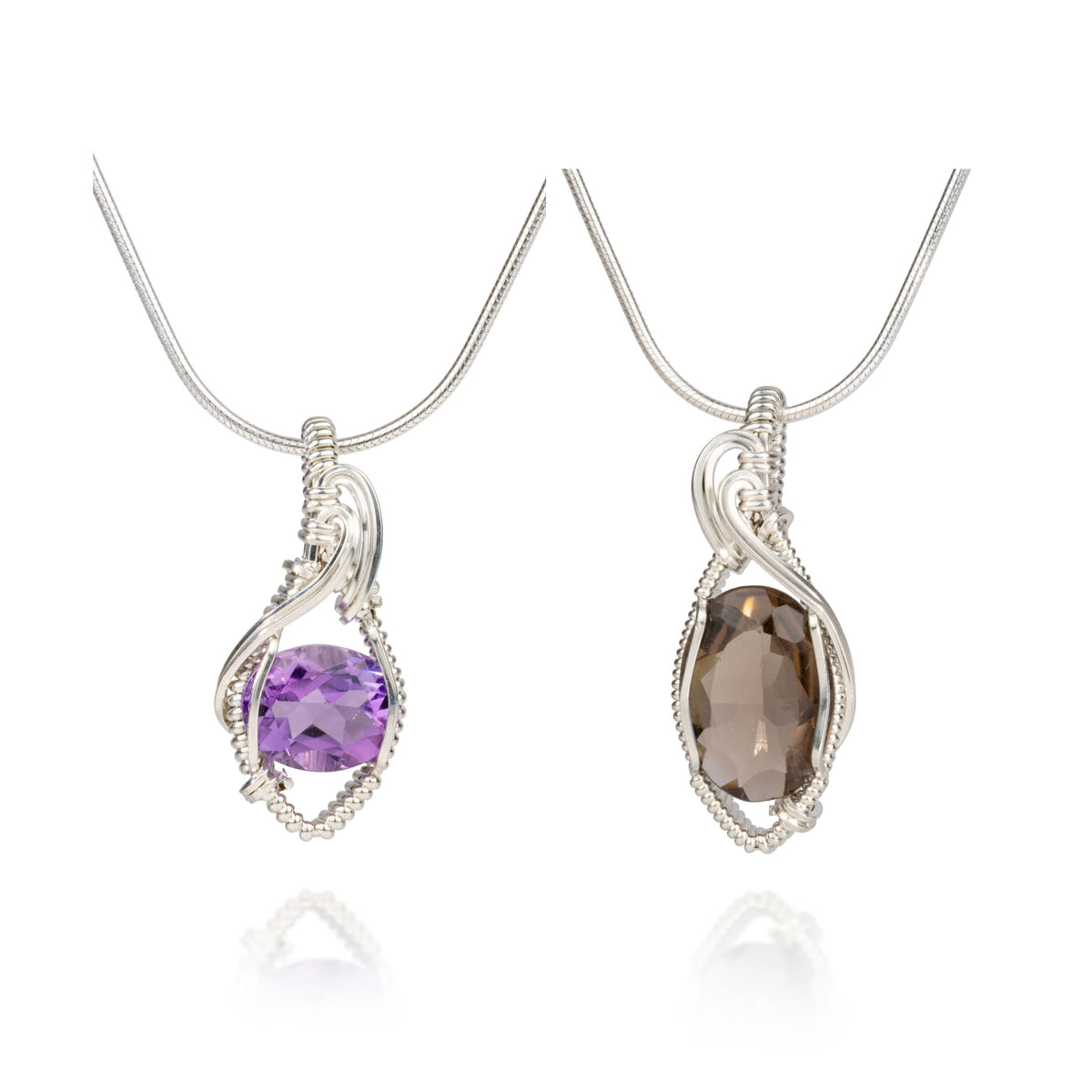 Two sterling silver pendants that are wire wrapped with faceted stones